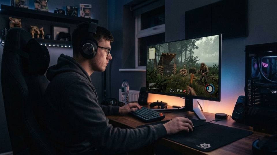 First-time gaming PC buyer at a clean desk setup with Ginger6 entry-level gaming PC