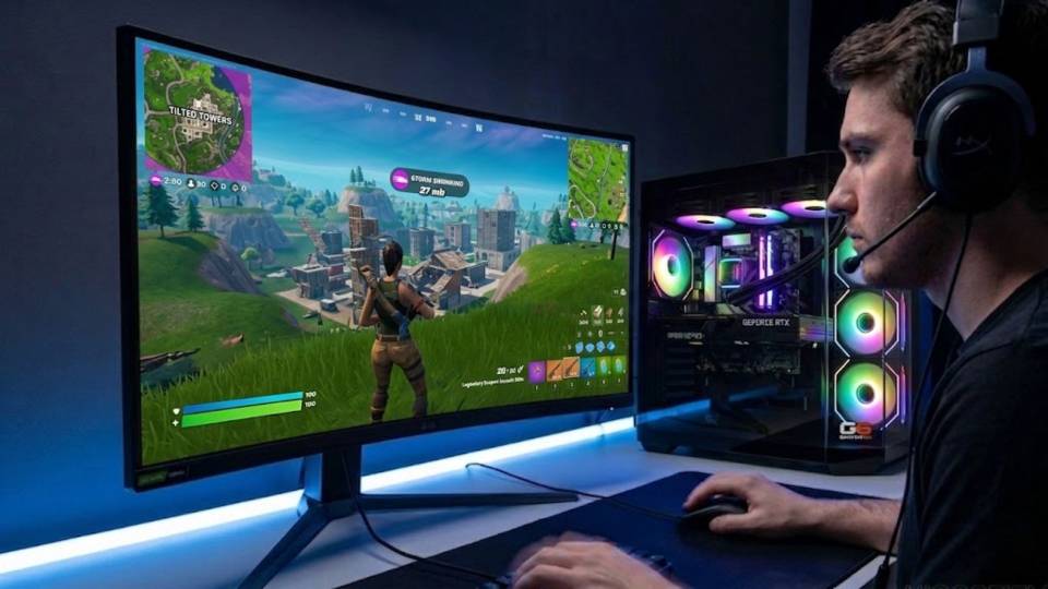 Ginger6 gaming PC in a Fortnite desk setup — Epic settings visible on monitor, clean cable management through side panel